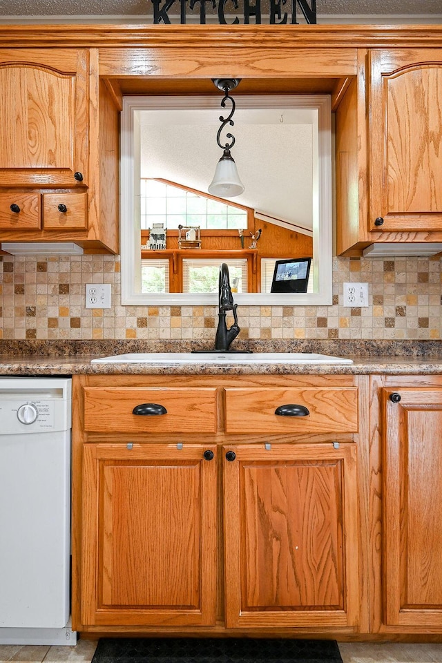 kitchen with dishwasher, tasteful backsplash, and sink