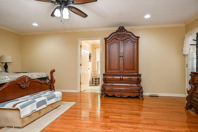 bedroom featuring a textured ceiling, light hardwood / wood-style flooring, ceiling fan, and ornamental molding