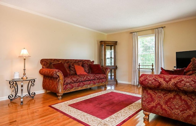 living room featuring wood-type flooring and crown molding