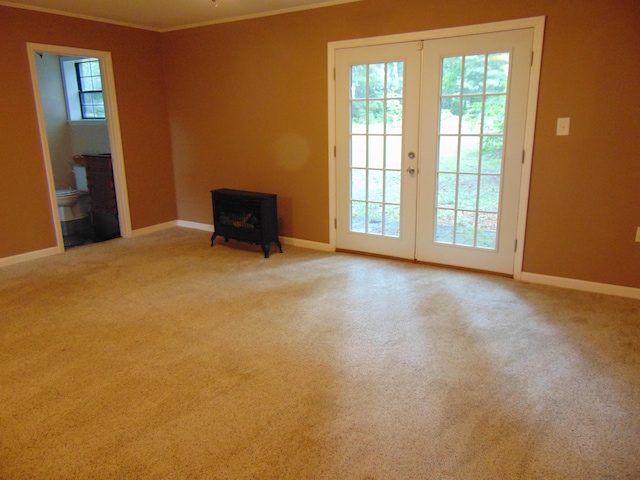668 Mount Zion Rd NW, Georgetown, TN 37336 - unfurnished living room featuring a wood stove, ornamental molding, french doors, and carpet floors