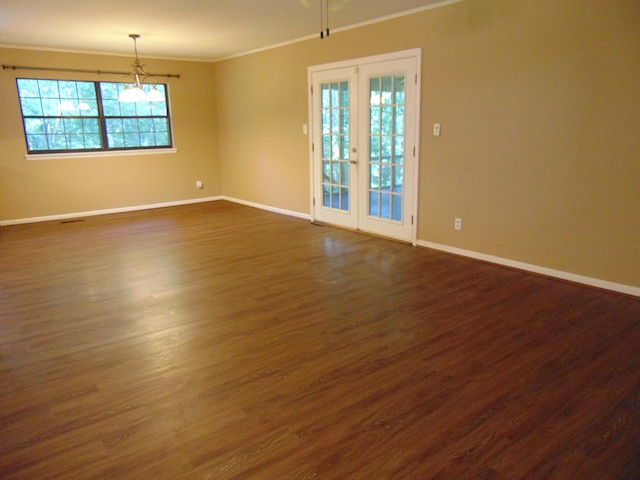668 Mount Zion Rd NW, Georgetown, TN 37336 - spare room featuring crown molding, healthy amount of natural light, dark wood finished floors, and a chandelier