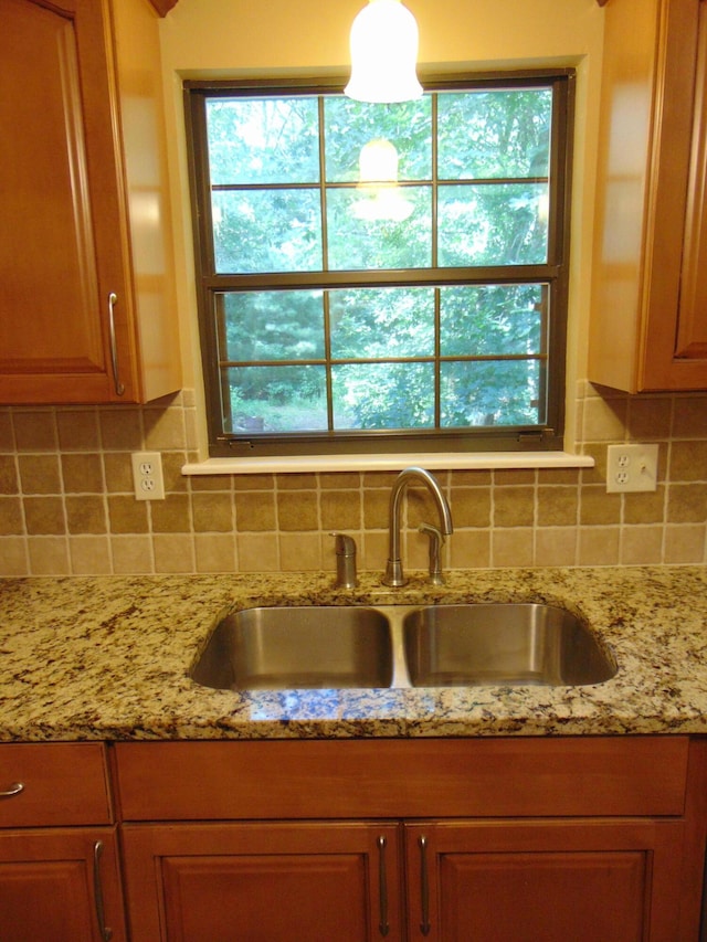 668 Mount Zion Rd NW, Georgetown, TN 37336 - kitchen featuring tasteful backsplash, light stone countertops, and brown cabinets