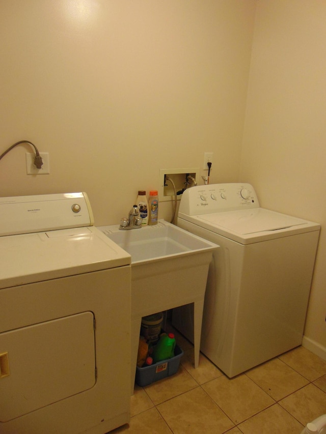 668 Mount Zion Rd NW, Georgetown, TN 37336 - laundry area featuring separate washer and dryer, light tile patterned flooring, and baseboards