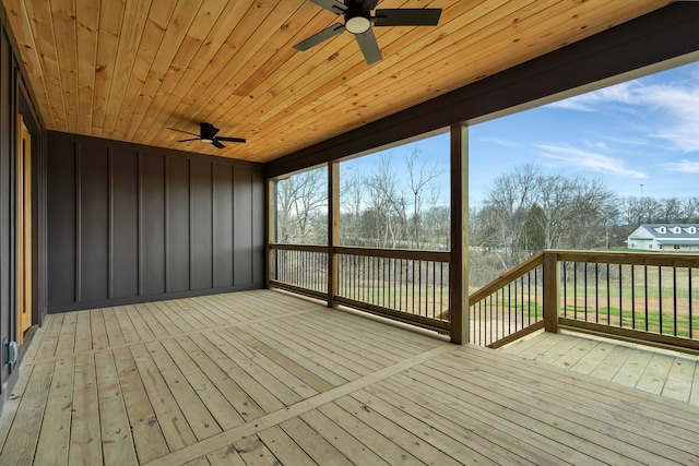 wooden deck featuring a ceiling fan