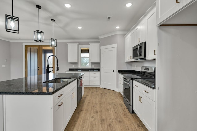 kitchen featuring visible vents, white cabinetry, open floor plan, stainless steel microwave, and dark countertops