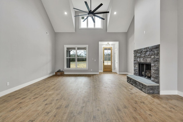 kitchen featuring white cabinets, stainless steel appliances, a kitchen island with sink, and decorative light fixtures