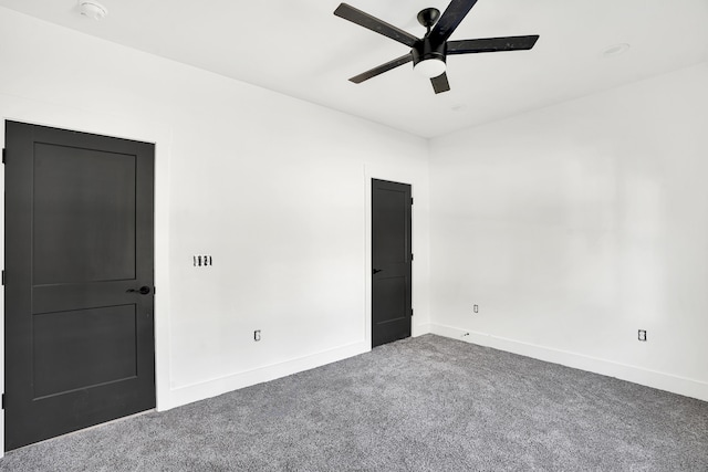 empty room with ceiling fan and carpet