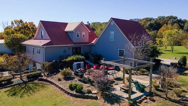 rear view of property with a pergola, a patio, and a yard