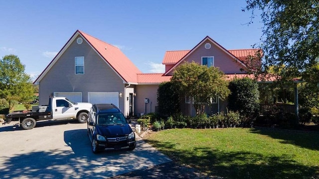 view of front of property with a front lawn and a garage