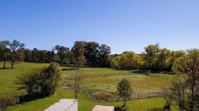 view of home's community with a yard and a rural view