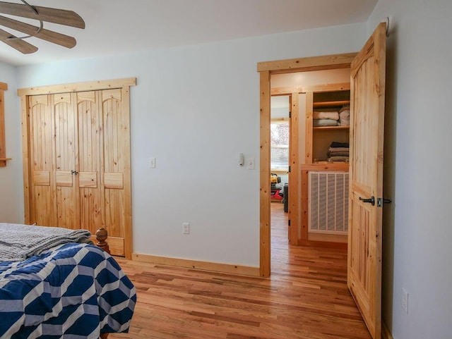 bedroom featuring ceiling fan, light wood-type flooring, and radiator heating unit