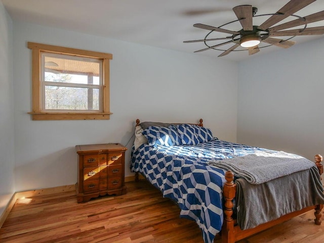 bedroom with ceiling fan and hardwood / wood-style flooring