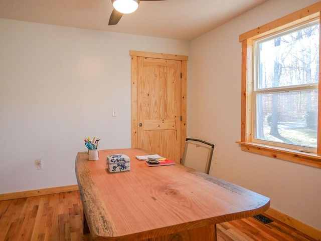 dining area with ceiling fan and hardwood / wood-style flooring