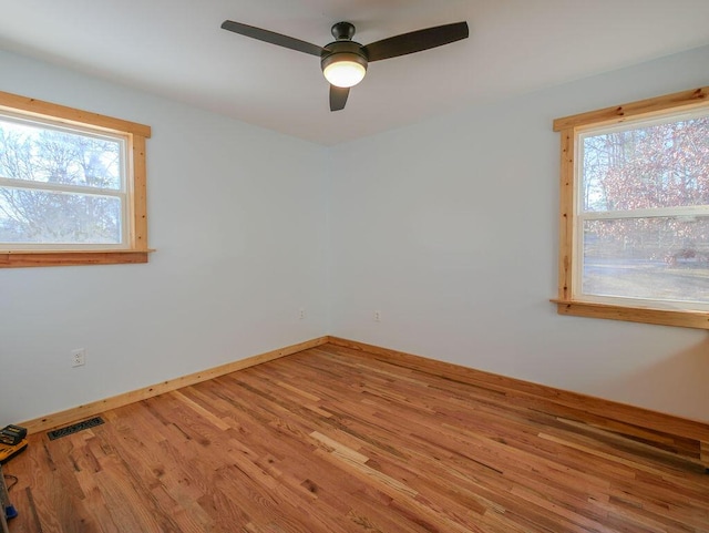 unfurnished room with ceiling fan and wood-type flooring