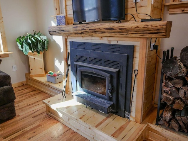 room details featuring hardwood / wood-style flooring and a wood stove