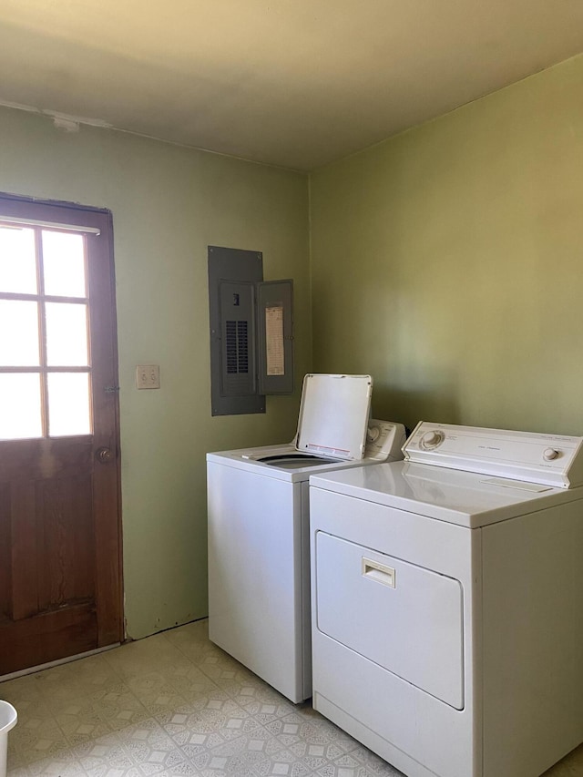 clothes washing area with electric panel and independent washer and dryer