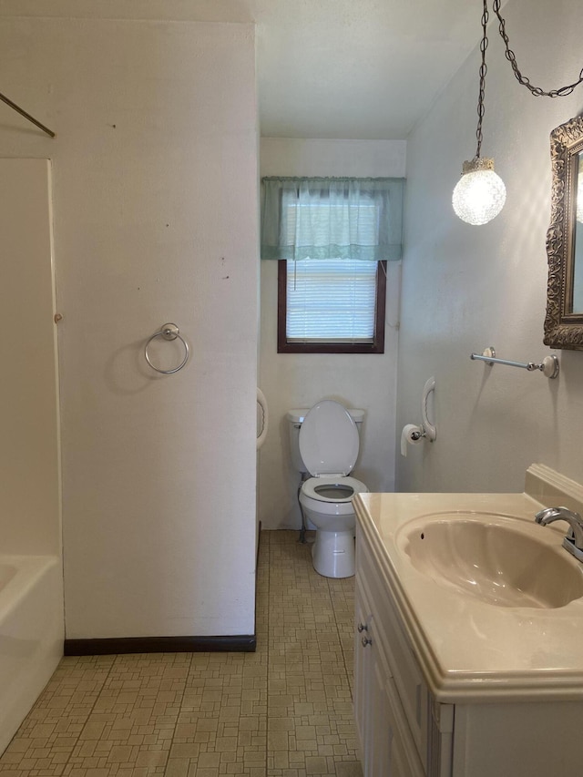 bathroom featuring a bathtub, toilet, and vanity