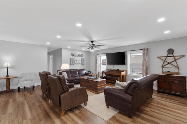 living room featuring wood-type flooring and ceiling fan