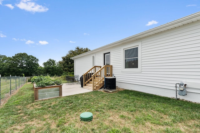 view of yard with a patio and central air condition unit