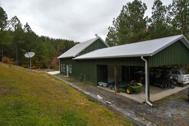 view of side of home with a yard