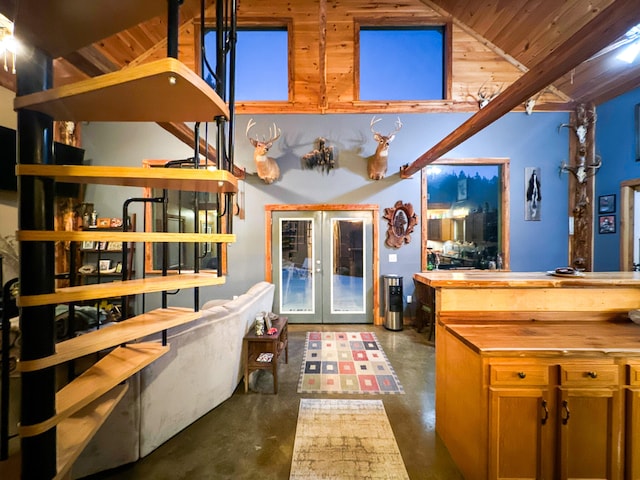 interior space featuring french doors, lofted ceiling, and wooden ceiling