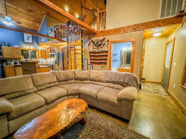 living room featuring wooden ceiling, high vaulted ceiling, ceiling fan, concrete floors, and beam ceiling