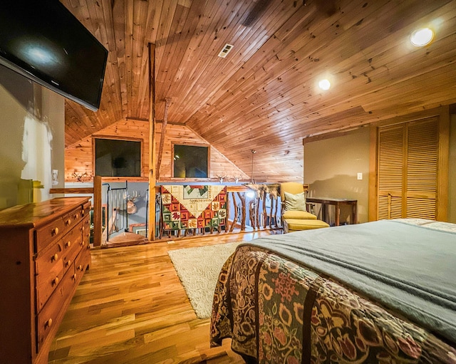 bedroom with wood walls, hardwood / wood-style flooring, lofted ceiling, and wood ceiling