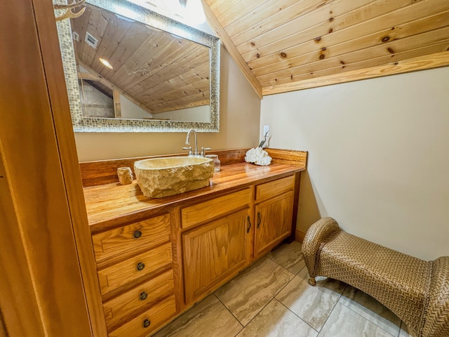 bathroom featuring tile patterned flooring, vanity, vaulted ceiling, and wooden ceiling