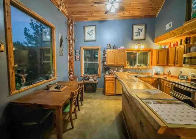 kitchen featuring sink, wooden ceiling, stainless steel appliances, and light carpet