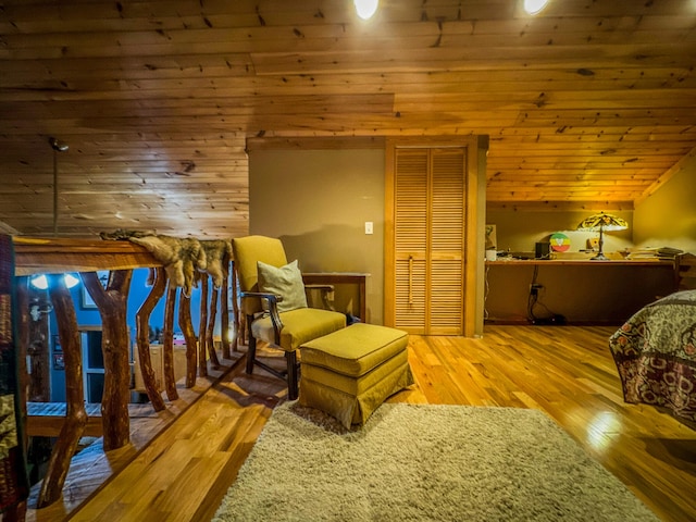 bedroom featuring light hardwood / wood-style flooring, a closet, and wood ceiling