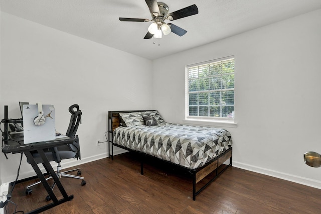 bedroom featuring baseboards, ceiling fan, and wood finished floors