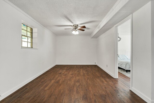 unfurnished room with crown molding, a ceiling fan, dark wood-style flooring, and a textured ceiling