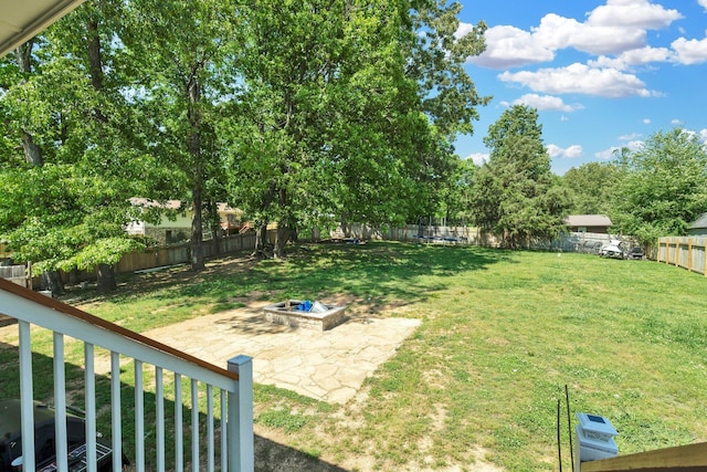 view of yard featuring a fenced backyard, a fire pit, and a patio area