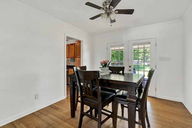 dining area featuring a ceiling fan, baseboards, french doors, and light wood finished floors