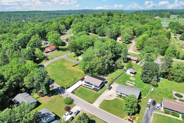 drone / aerial view with a wooded view