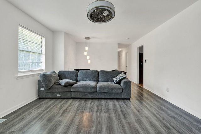 living room featuring baseboards and dark wood-style floors