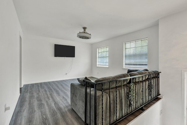 living area featuring baseboards and dark wood finished floors