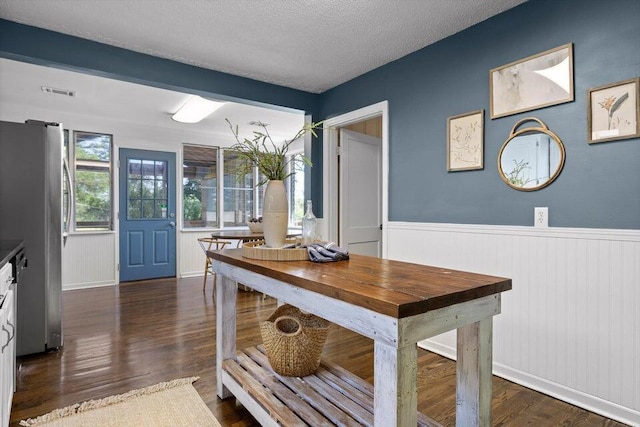 205 W Daytona Dr, Chattanooga, TN 37415 - dining space with dark wood-style floors, a wainscoted wall, and a textured ceiling