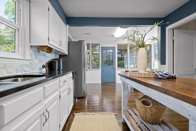 205 W Daytona Dr, Chattanooga, TN 37415 - kitchen featuring white cabinetry, tasteful backsplash, dishwasher, dark wood-style floors, and a textured ceiling