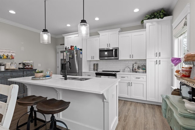 3914 Dogwood Valley Rd, Tunnel Hill, GA 30755 - kitchen with white cabinets, a kitchen bar, appliances with stainless steel finishes, and an island with sink