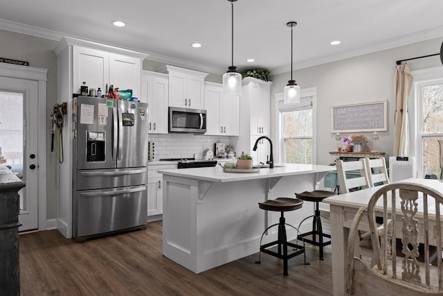3914 Dogwood Valley Rd, Tunnel Hill, GA 30755 - kitchen featuring light countertops, crown molding, dark wood-style flooring, decorative backsplash, and appliances with stainless steel finishes