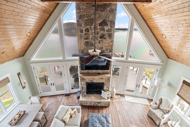 living room featuring wood ceiling, beam ceiling, and french doors