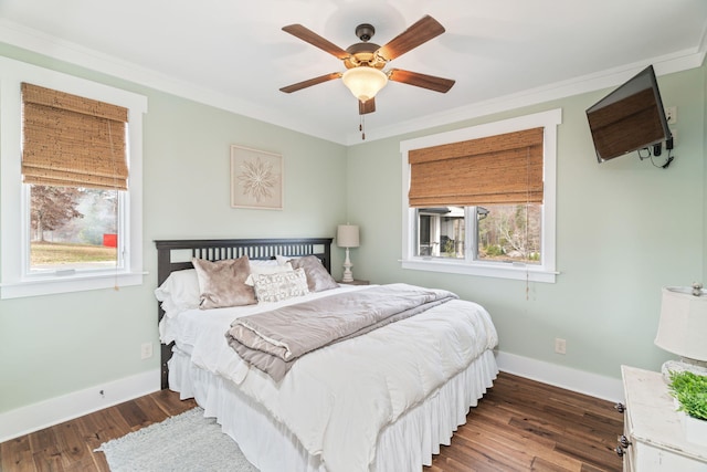 bedroom featuring ceiling fan, multiple windows, dark hardwood / wood-style floors, and crown molding