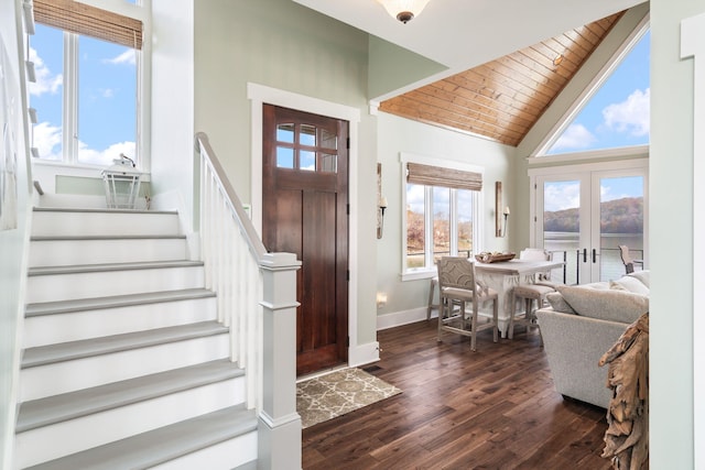 foyer entrance with high vaulted ceiling, french doors, dark wood-type flooring, and wood ceiling