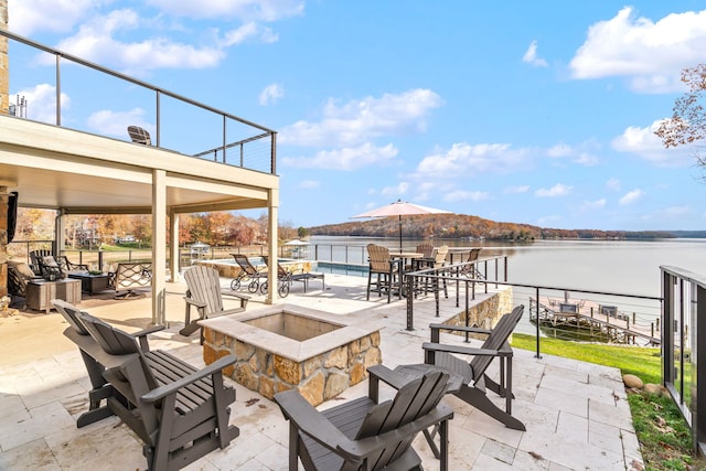 view of patio / terrace featuring a fire pit and a water view