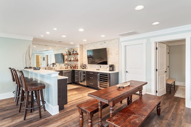 interior space featuring dishwasher, beverage cooler, crown molding, and dark hardwood / wood-style floors