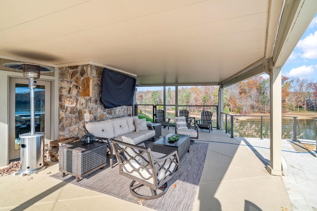 view of patio with an outdoor living space and a water view