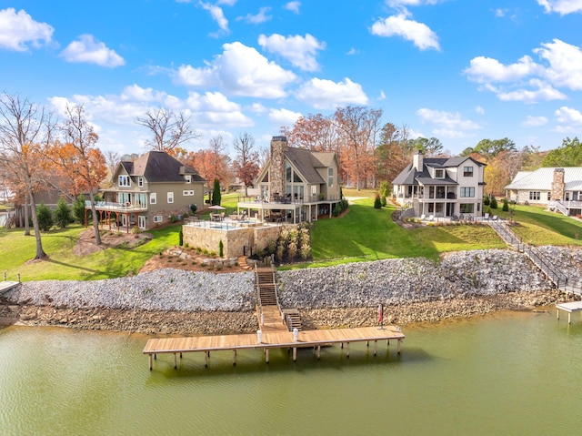 dock area featuring a water view and a lawn