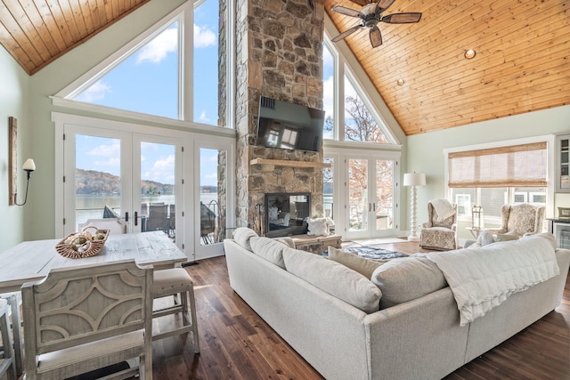 living room featuring high vaulted ceiling, wooden ceiling, french doors, and a fireplace