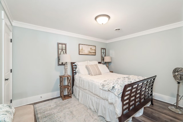 bedroom with dark wood-type flooring and crown molding